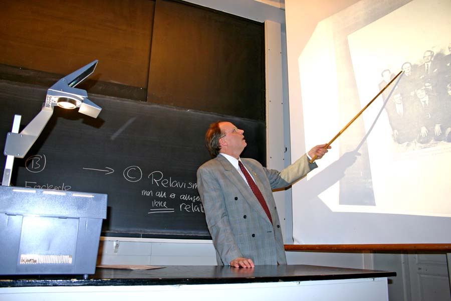 Bent Raymond Joergensen pointing at different scientists on a photo